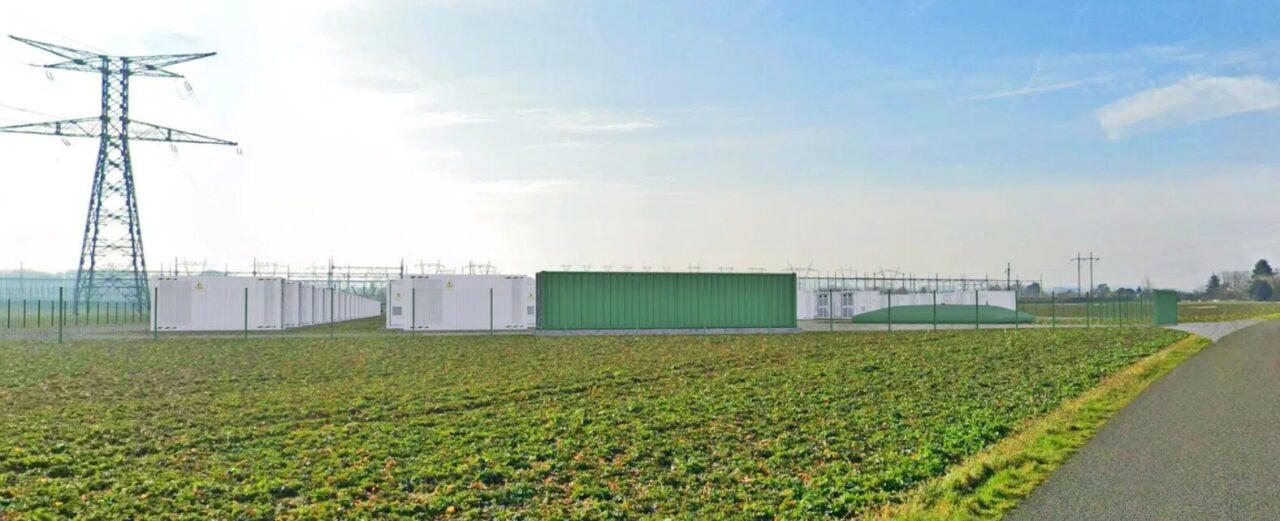 Large-scale lithium-ion battery energy storage system containers installed at a solar farm site.