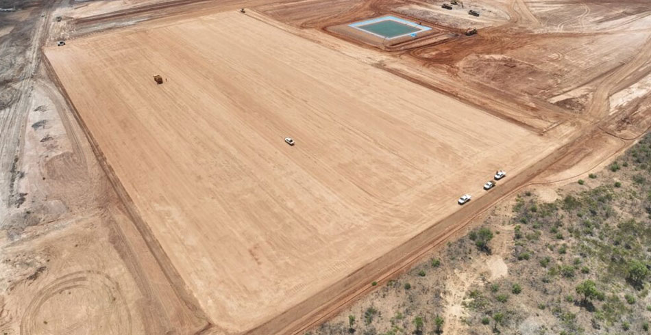 Aerial view of a massive hybrid solar and battery storage facility at a remote mining operation.