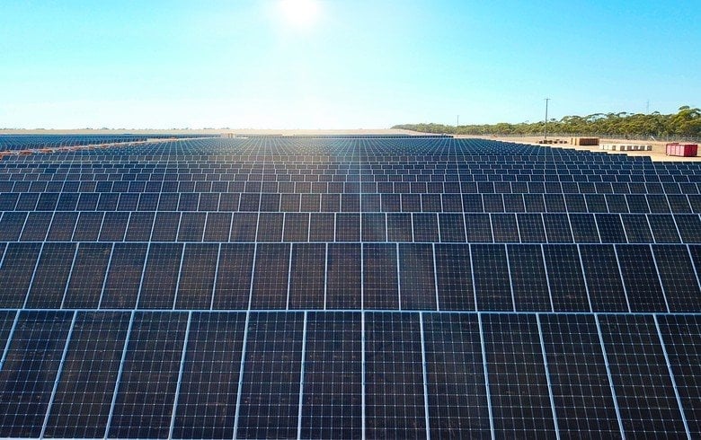 A rows of solar panels on a European residential rooftop under clear blue sky
