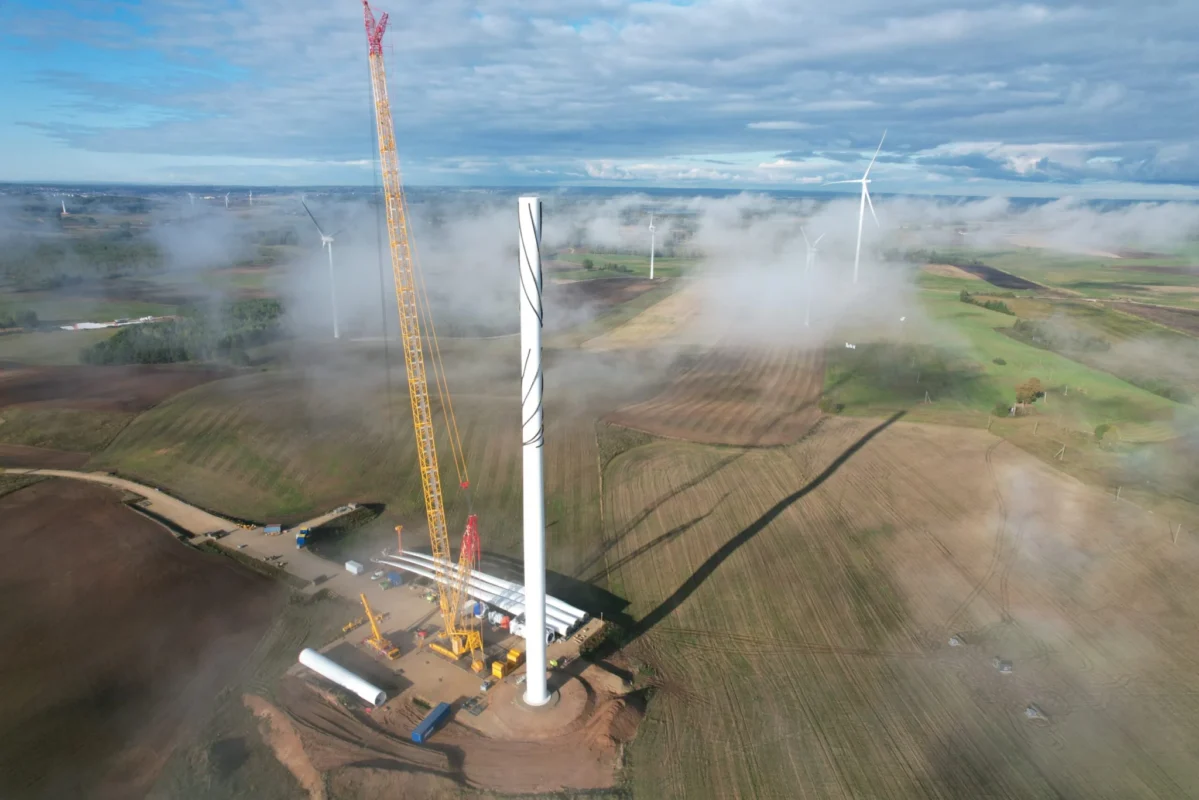 Aerial view of a large-scale solar farm under construction in a European landscape.