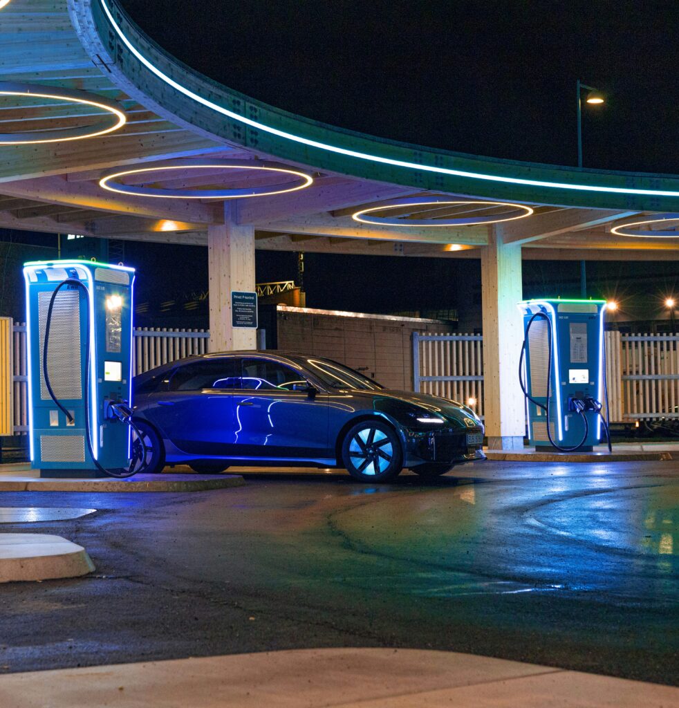 A technician inspecting a modern EV charging station connected to a smart solar power system