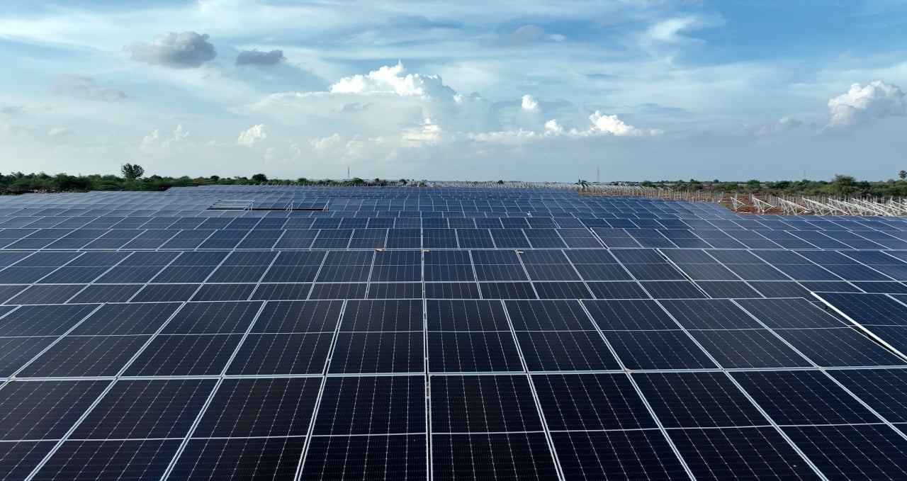Aerial view of a massive utility-scale solar plant in Rajasthan, India, featuring bifacial modules.