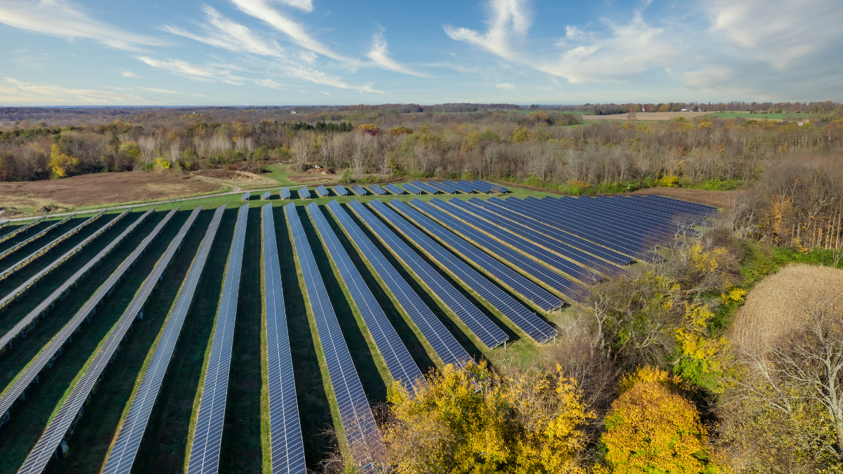Industrial factory rooftop solar installation overlooking the Italian landscape