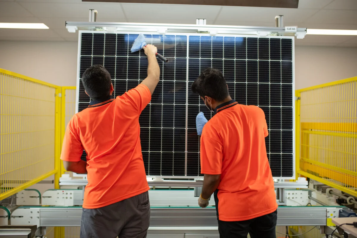 A stack of decommissioned solar modules at a European recycling facility awaiting silver extraction processing.