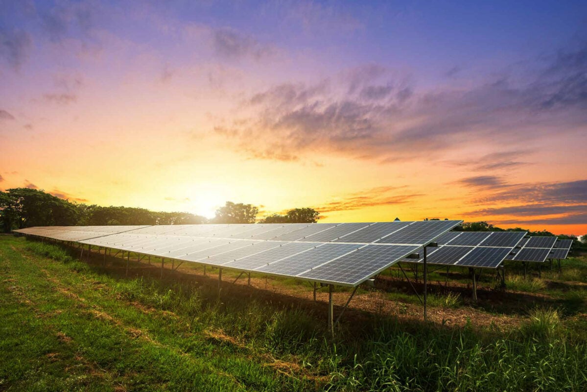 Aerial view of a large-scale solar panel installation under a clear sky