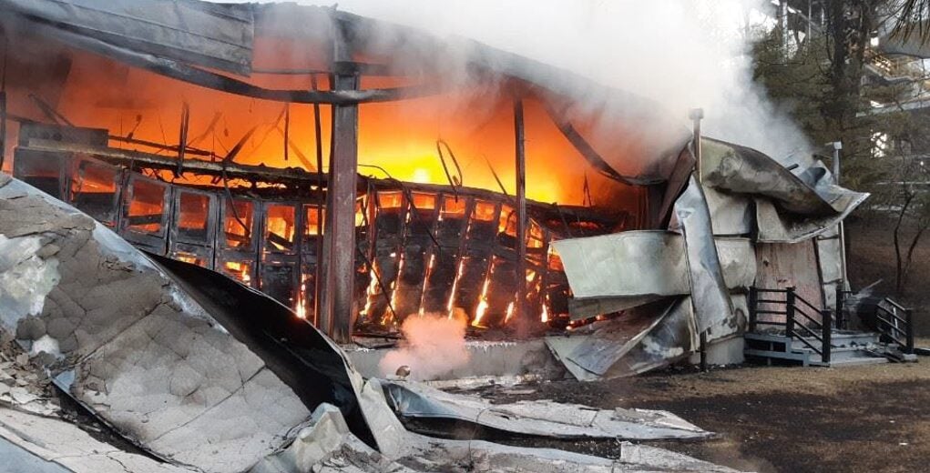 A technician inspecting a residential battery energy storage system during a routine safety audit