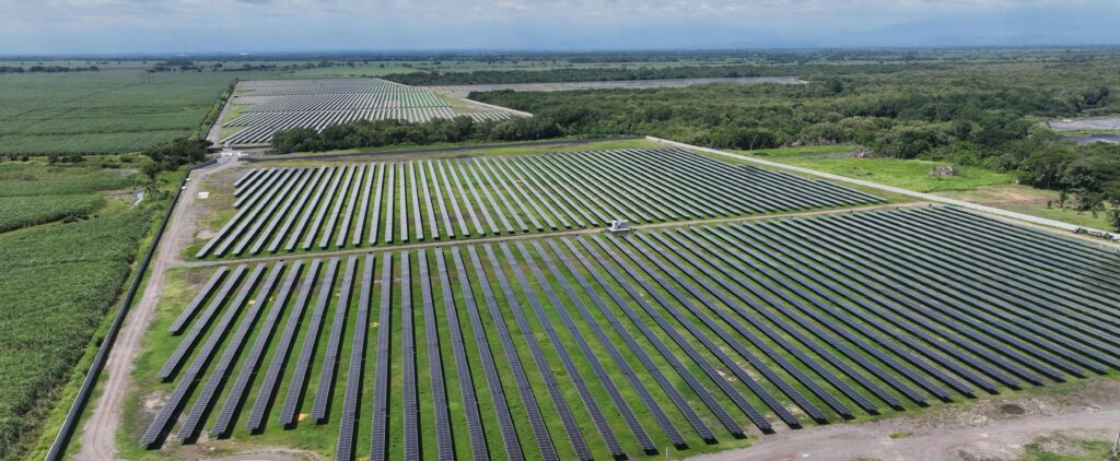 Solar panels installed in a Latin American landscape with mountains in the background
