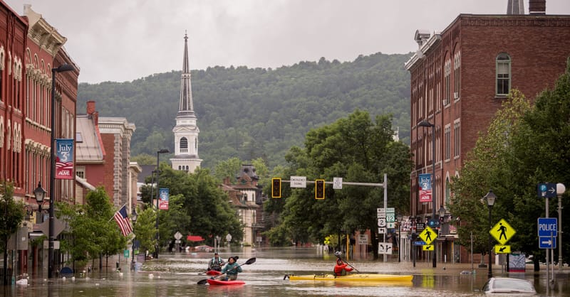 A row of solar panels installed in front of a modern industrial facility
