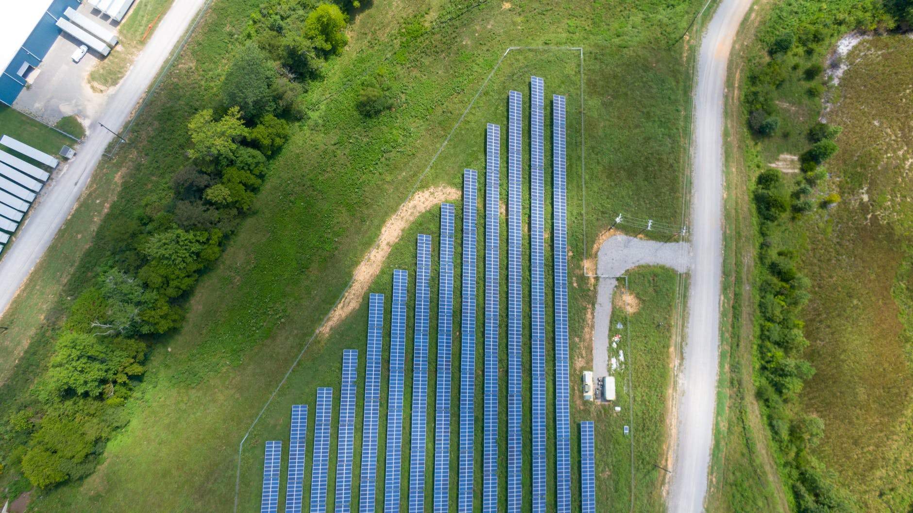 Aerial view of a sprawling utility-scale solar farm in a desert landscape.