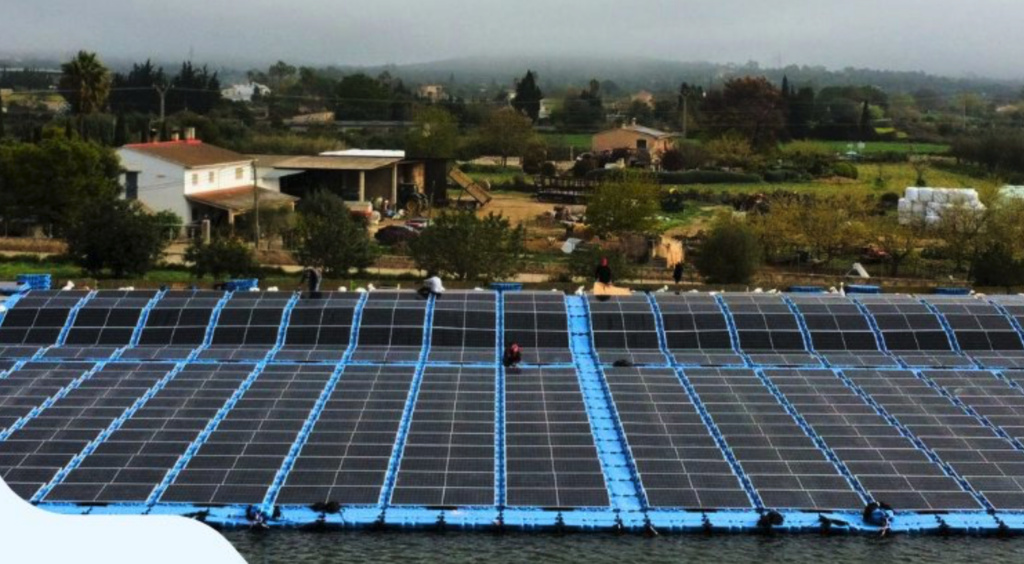 Workers installing floating solar panels on a reservoir in Mallorca under the Balearic sun.