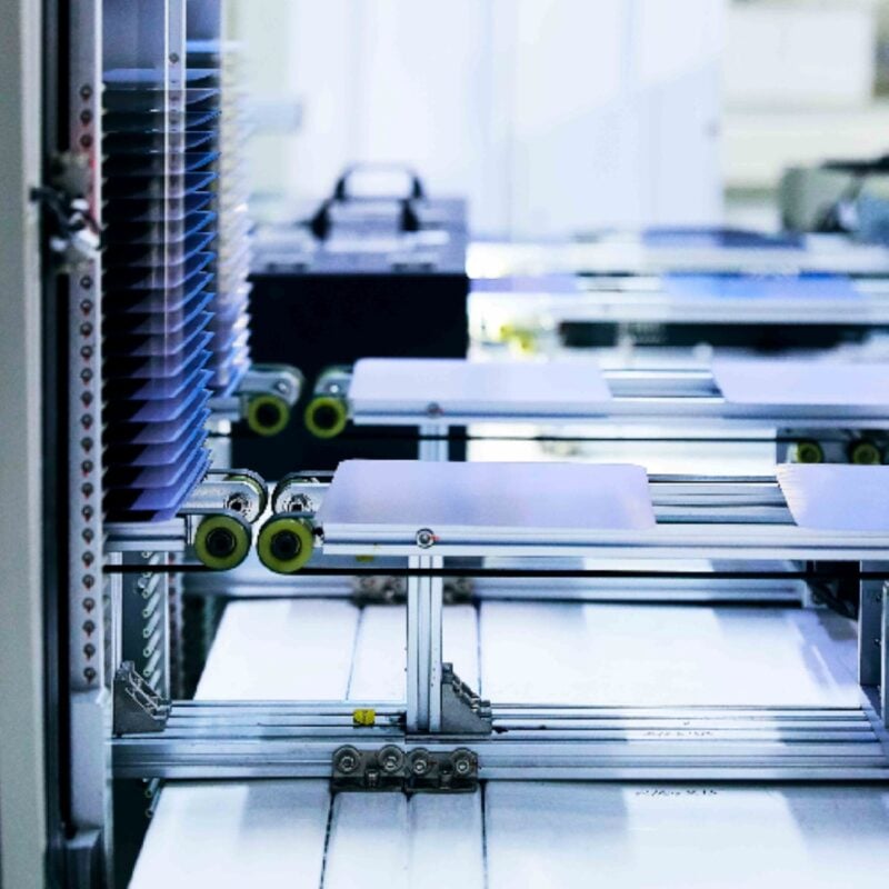 Close up of high-efficiency HJT solar cells on a manufacturing production line in India