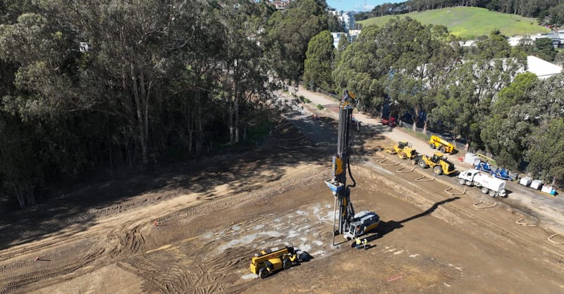 A massive utility-scale battery energy storage system installation located next to an urban arena.