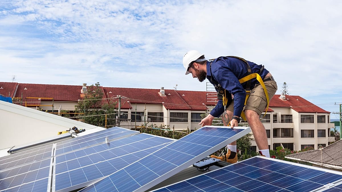 A residential rooftop in Europe featuring high-efficiency solar panels and a home battery storage unit.