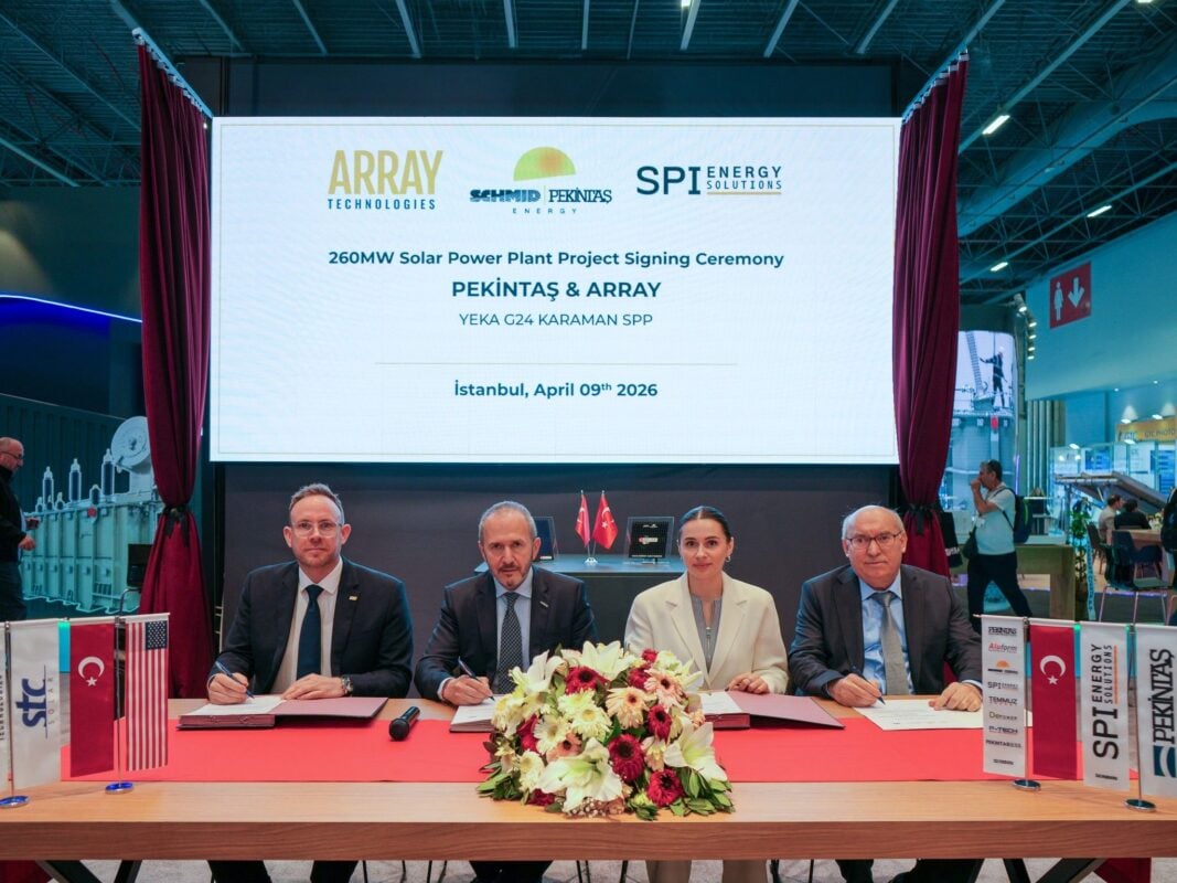 Array Technologies OmniTrack solar tracker system installed on uneven, hilly terrain at a utility-scale site.