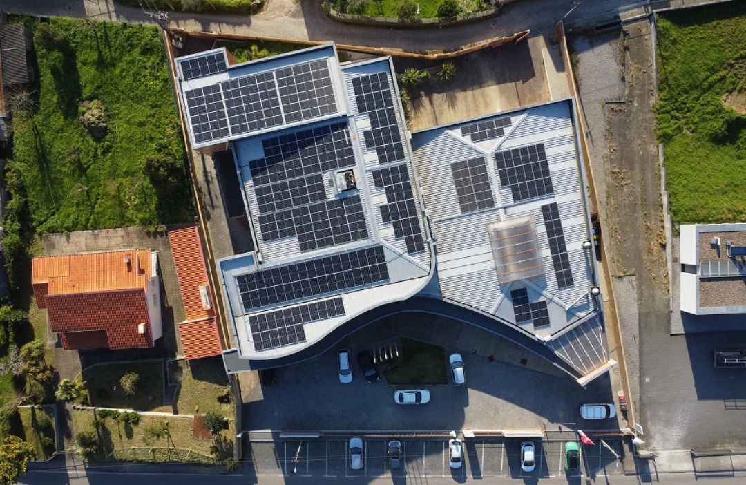 Modern residential complex in Portugal with solar panels integrated into a community energy sharing network.