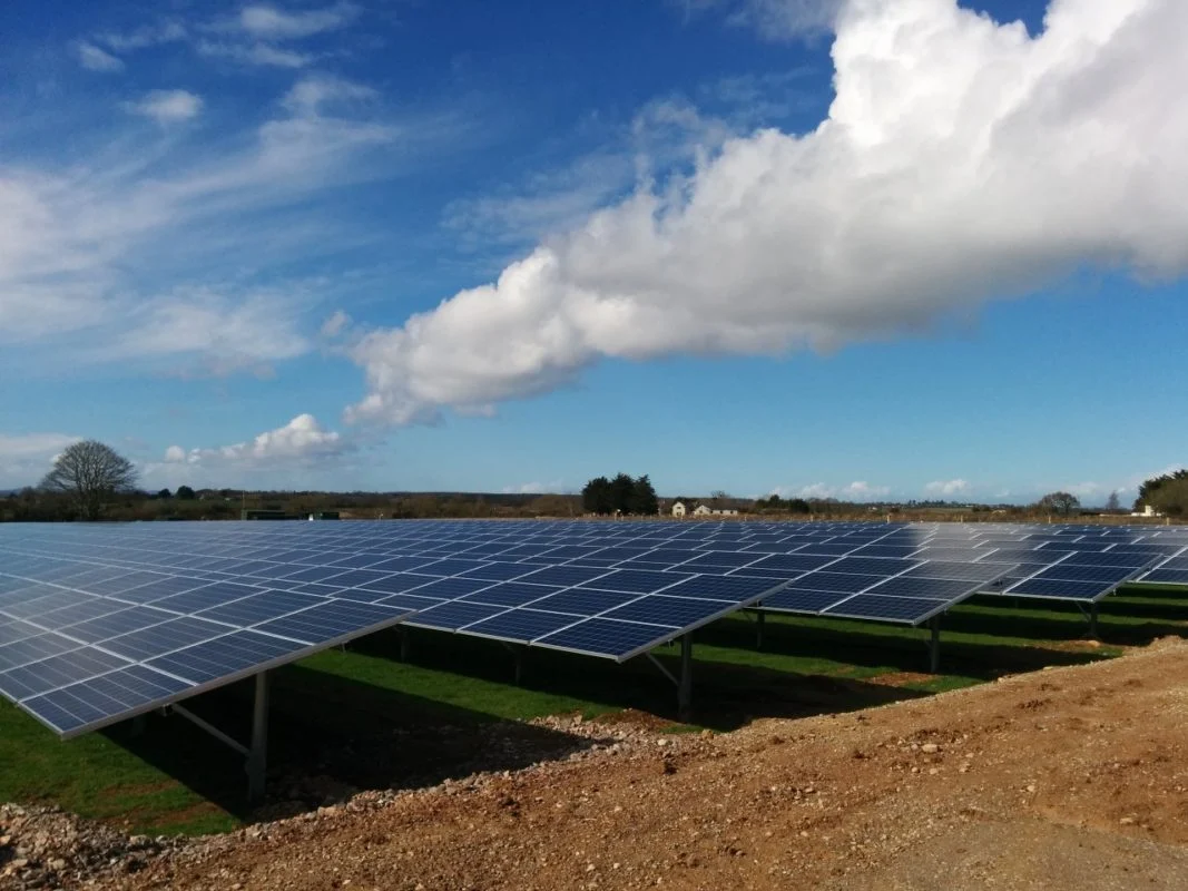 Large scale solar farm integrated with containerized battery energy storage systems in a rural field
