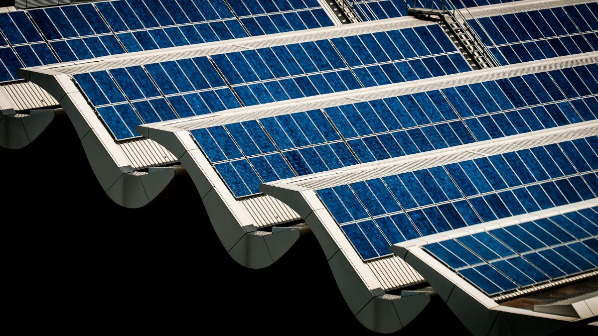 Industrial solar panels installed on a factory rooftop in a tropical climate