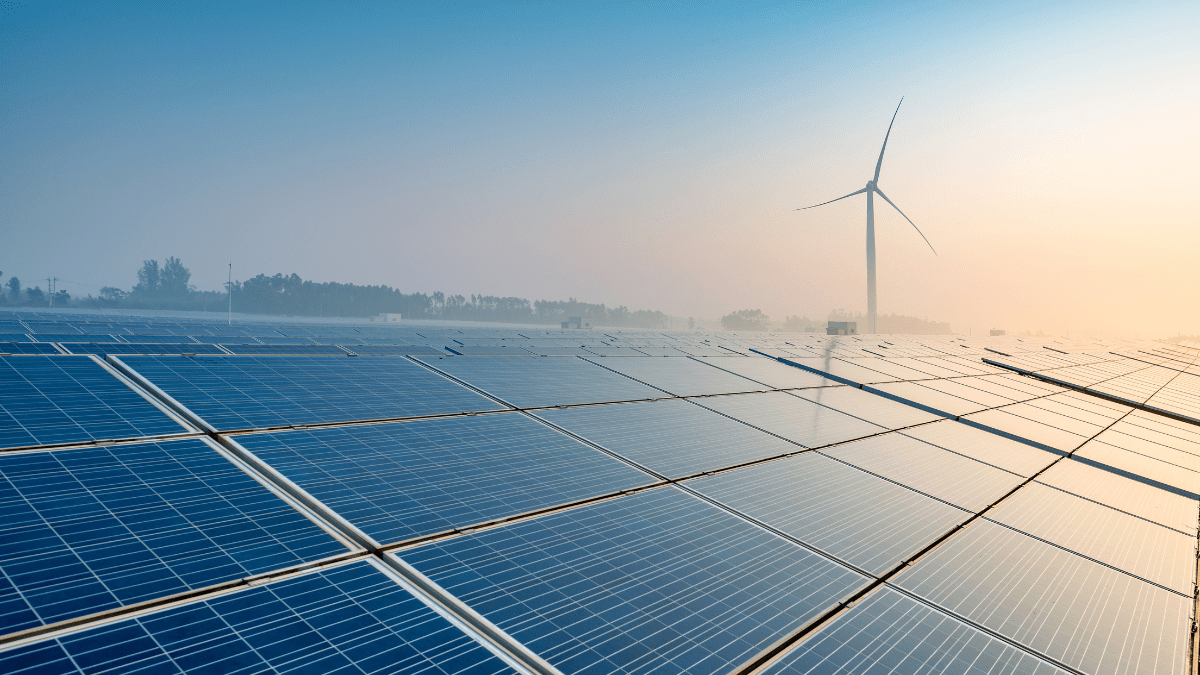 Large-scale utility solar array stretching across a semi-arid African landscape under a clear sky.