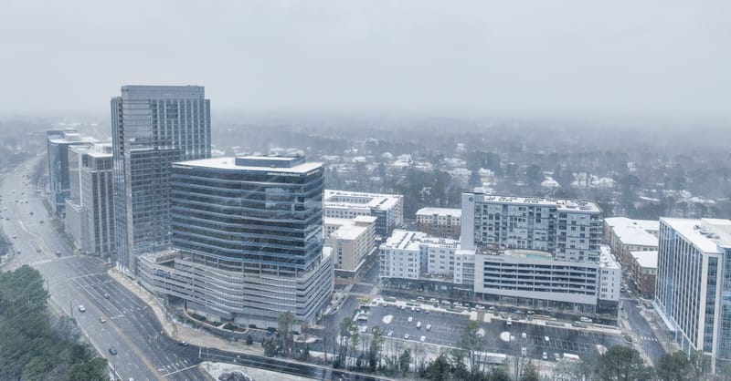 A modern digital thermostat displaying energy consumption data in a solar-powered European home.