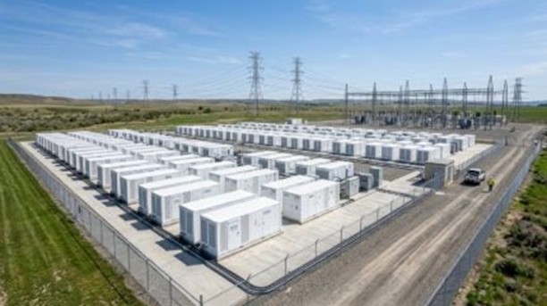 Large scale battery energy storage system containers next to a solar farm in rural Spain.
