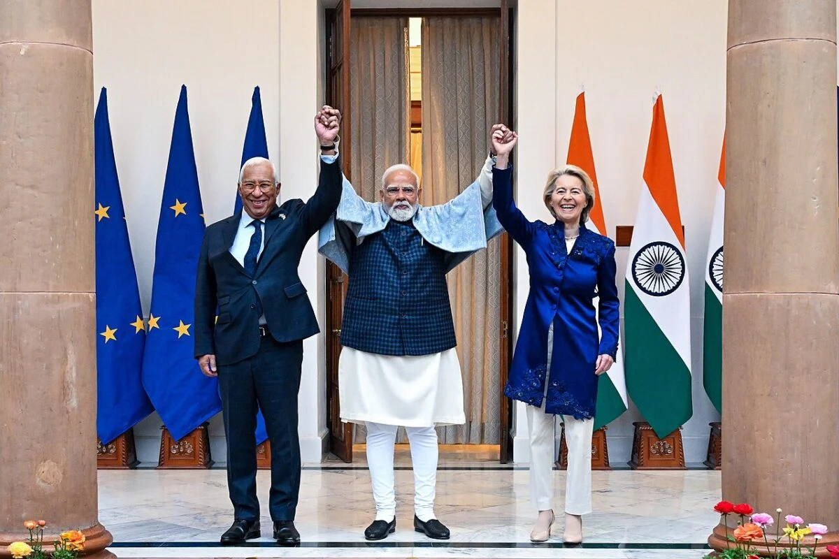 European and Indian flags with battery storage units in the background