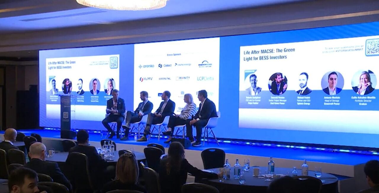 A grid-scale battery energy storage system (BESS) installation site under a clear Italian sky.