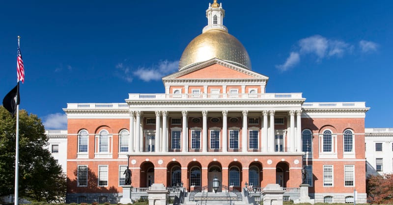A technician installing modern solar panels on a European residential rooftop during sunset
