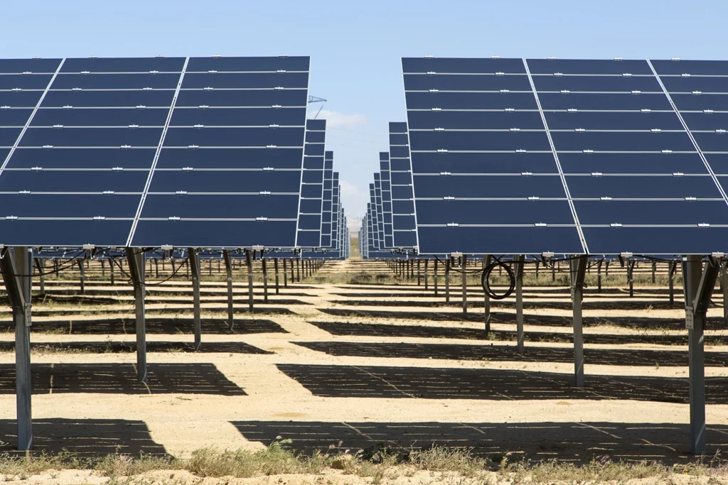 Aerial view of a massive utility-scale solar farm representing EDF's divested renewable assets.