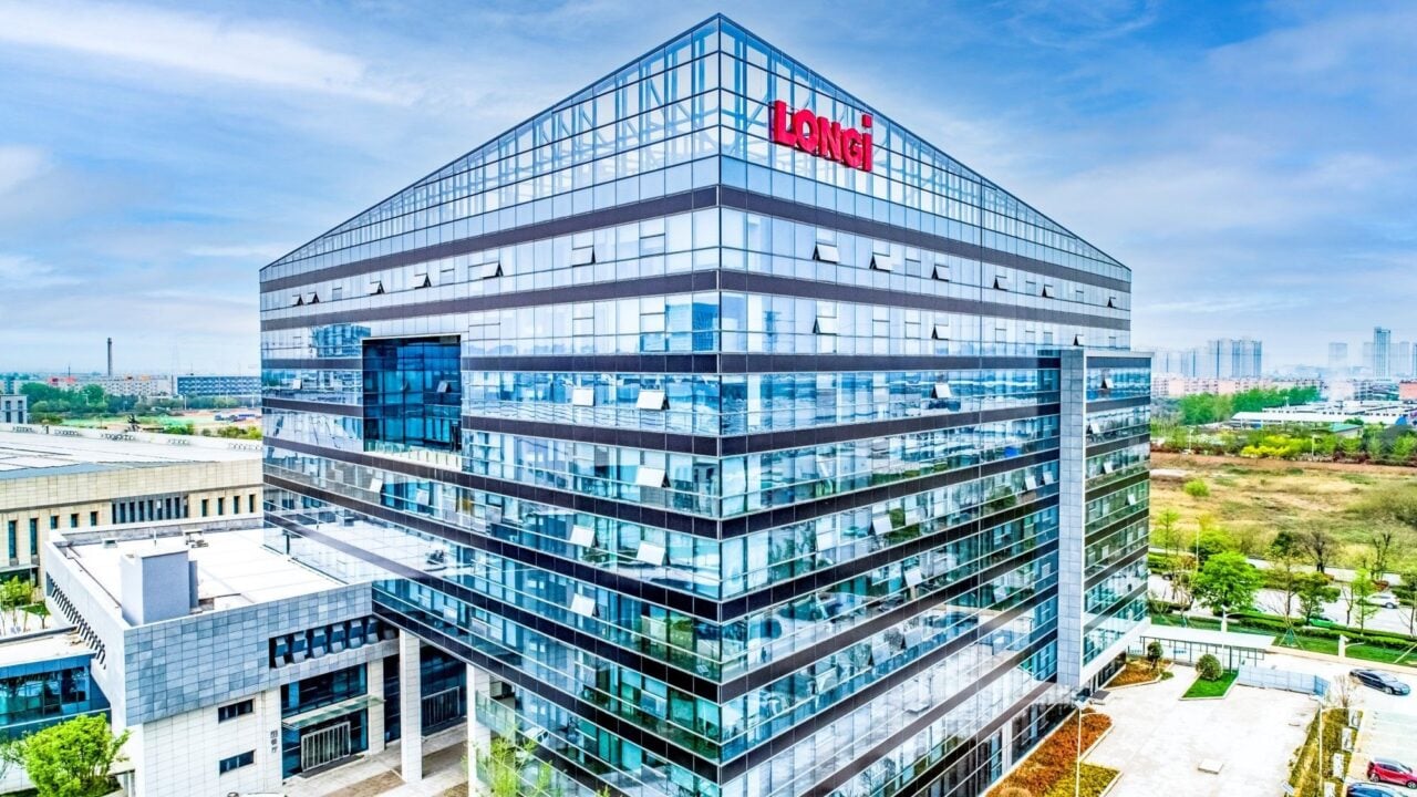 LONGi solar panels and battery storage units displayed together in a clean energy setup
