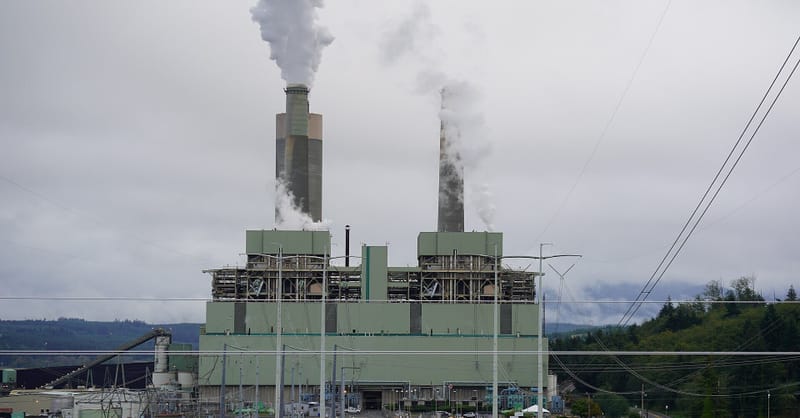 A modern solar farm integrated with large battery storage units under a bright sky
