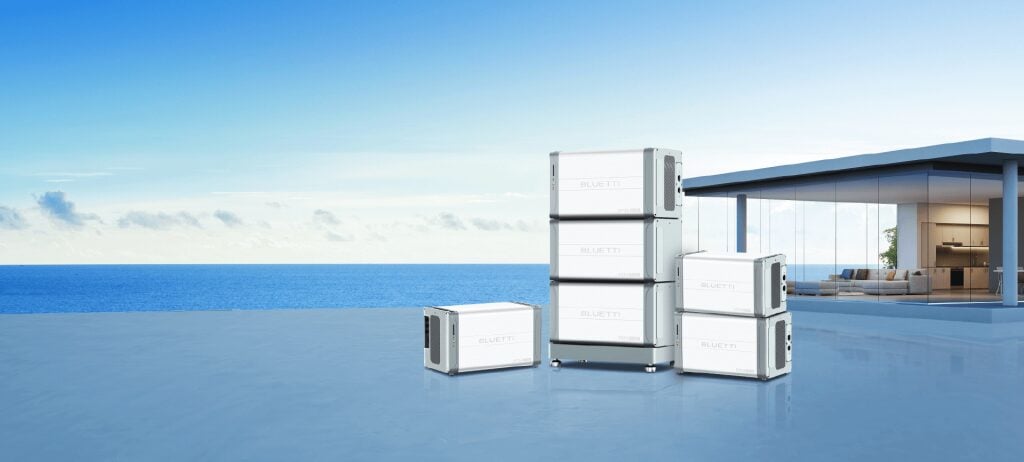 Bluetti portable power station sitting next to a residential solar panel installation setup.