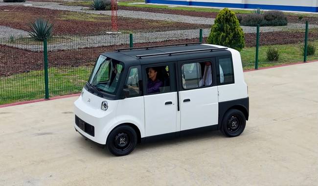 A compact, modern electric vehicle designed for urban transport with six seats.
