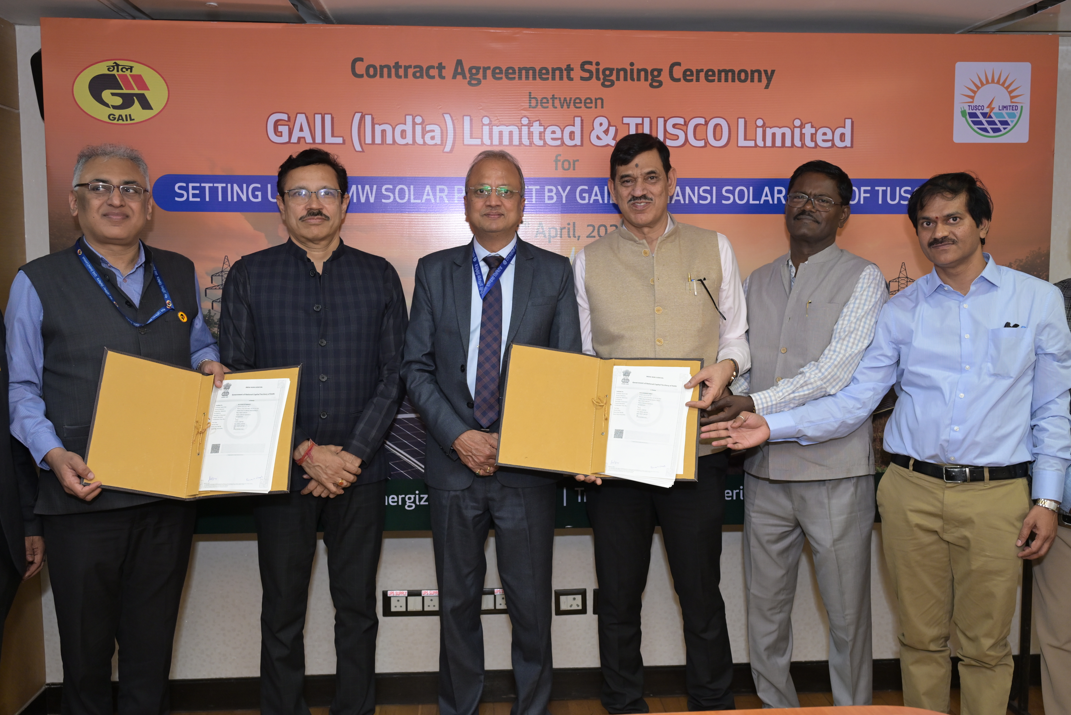 Large scale solar field under construction with rows of panels and battery storage units.