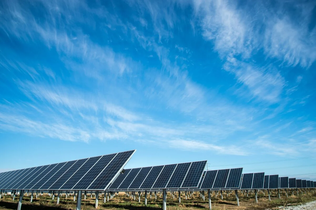 Aerial view of a utility-scale solar farm with integrated battery storage containers