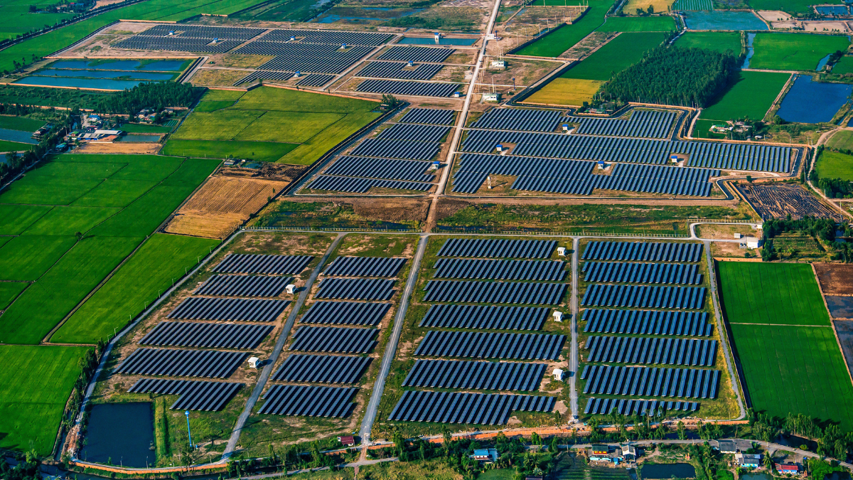 Aerial view of a large-scale solar farm integrated with agricultural land in Germany.