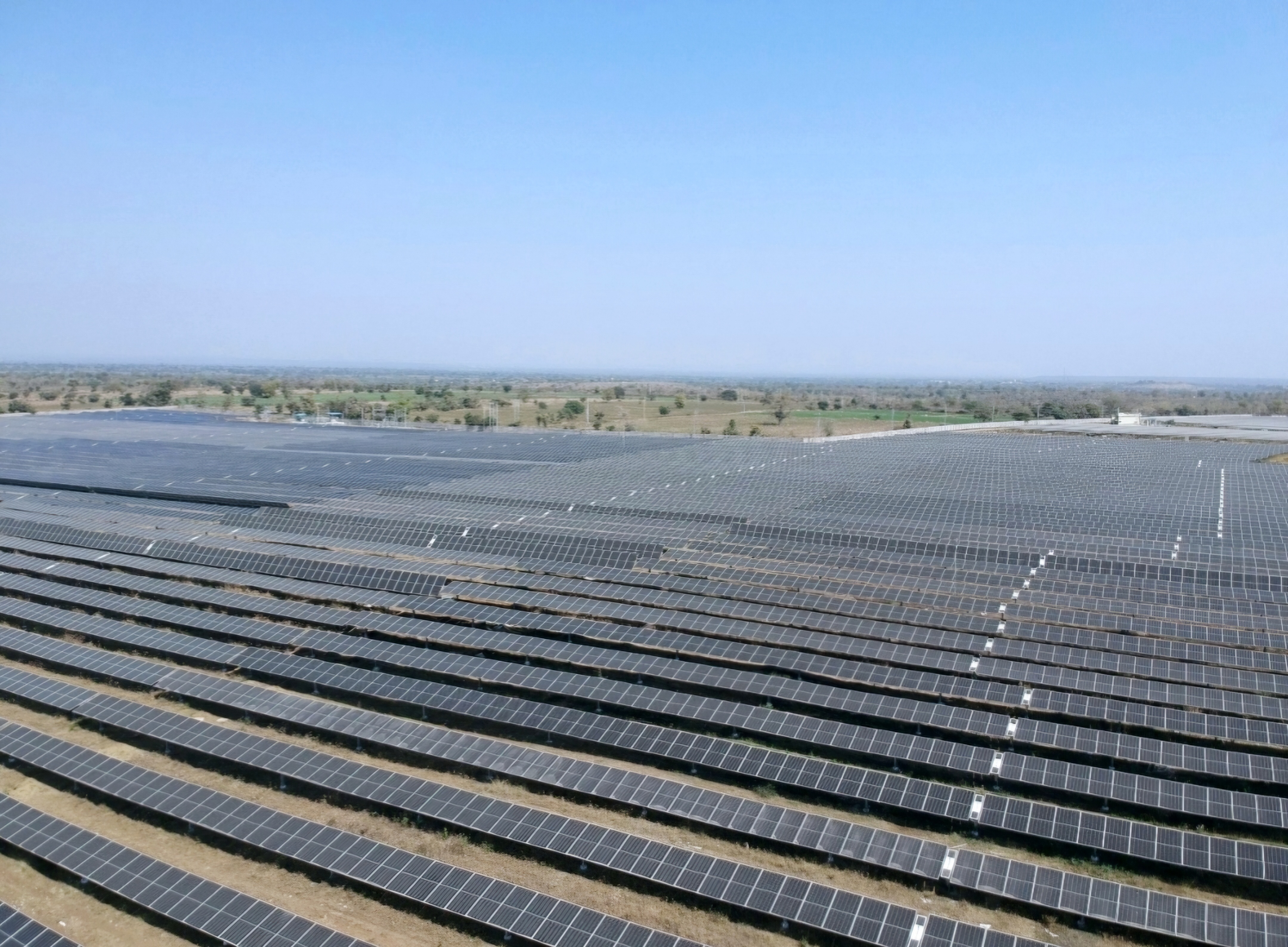 Large scale solar farm in Rajasthan, India under a clear blue sky