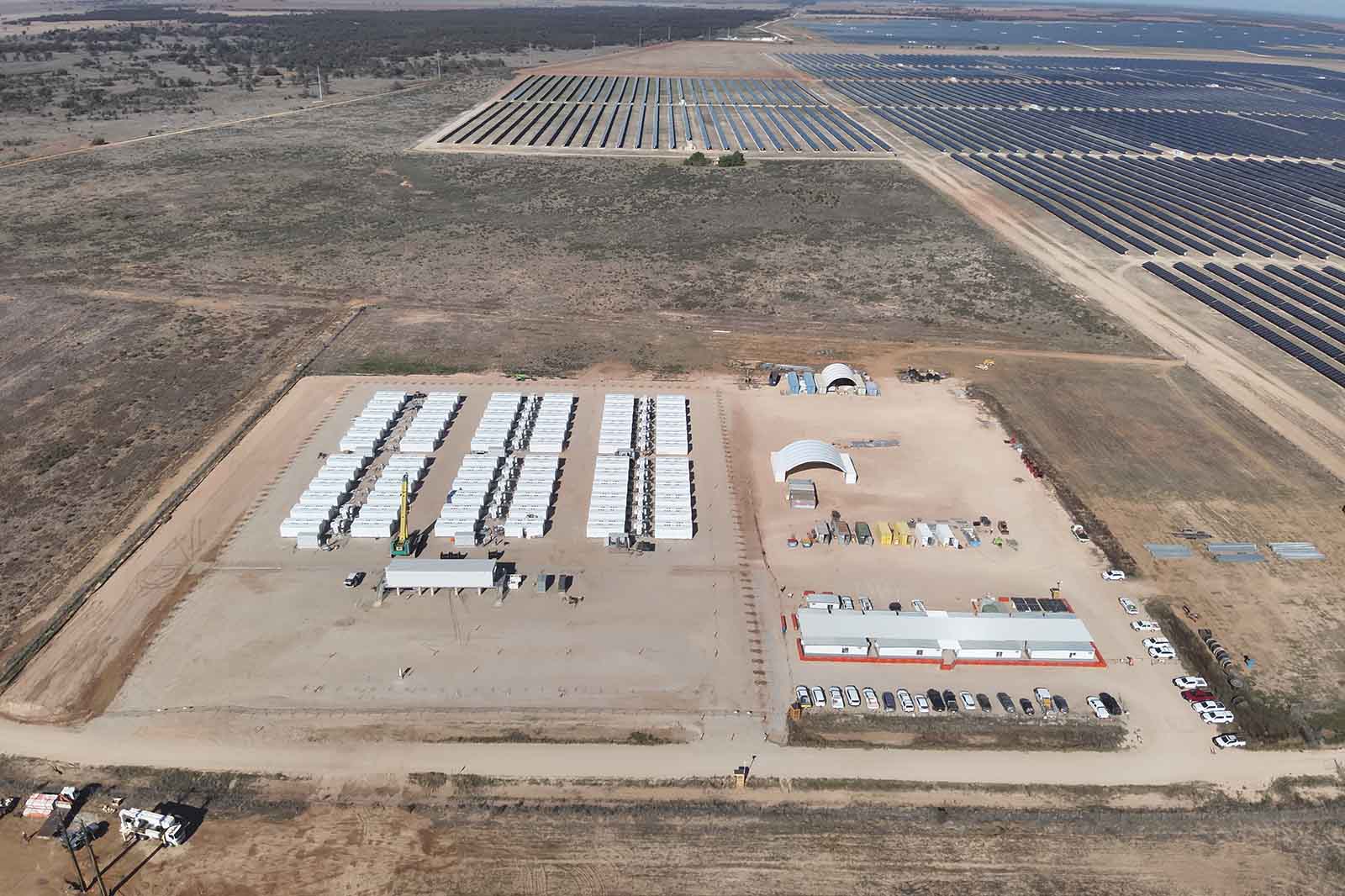 Large scale battery energy storage system containers in a row at a utility site.