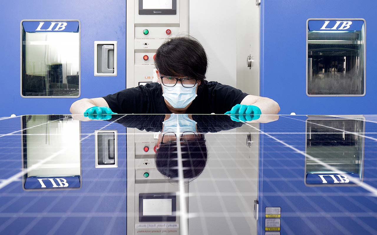 High-tech solar cell research lab with researchers examining silicon wafers under blue light