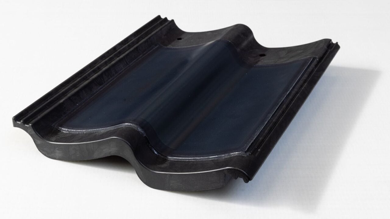 A prototype of a dark, slate-like solar roof tile developed in a laboratory setting.