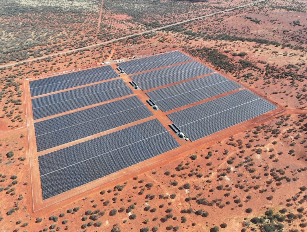 Aerial view of a large-scale industrial solar farm integrated with battery storage infrastructure