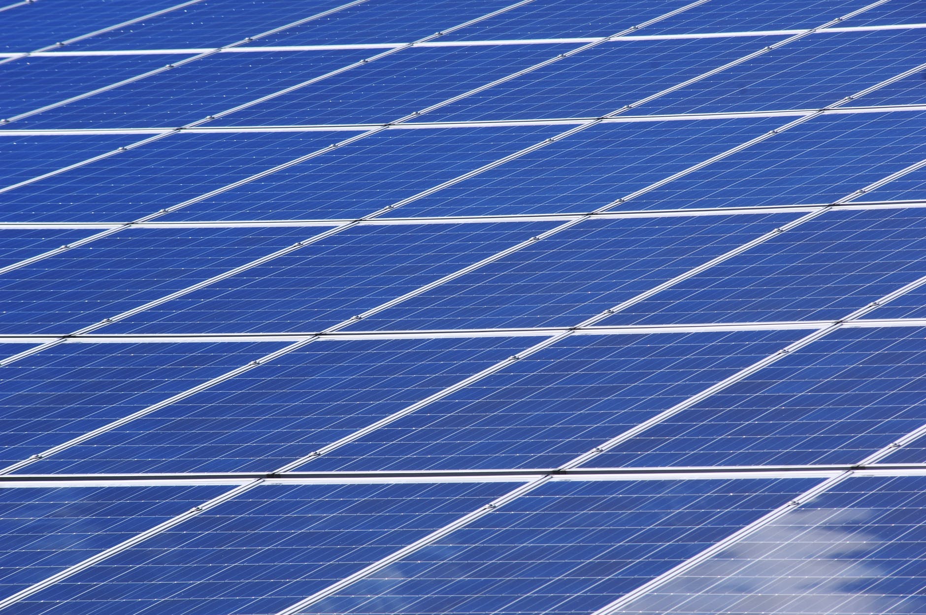 Solar panels installed on a residential rooftop under a clear blue sky