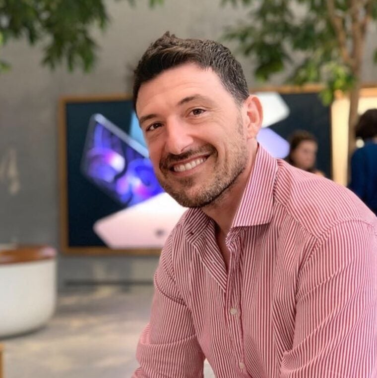 A large-scale ground-mount solar PV park in Italy bathed in golden hour sunlight.