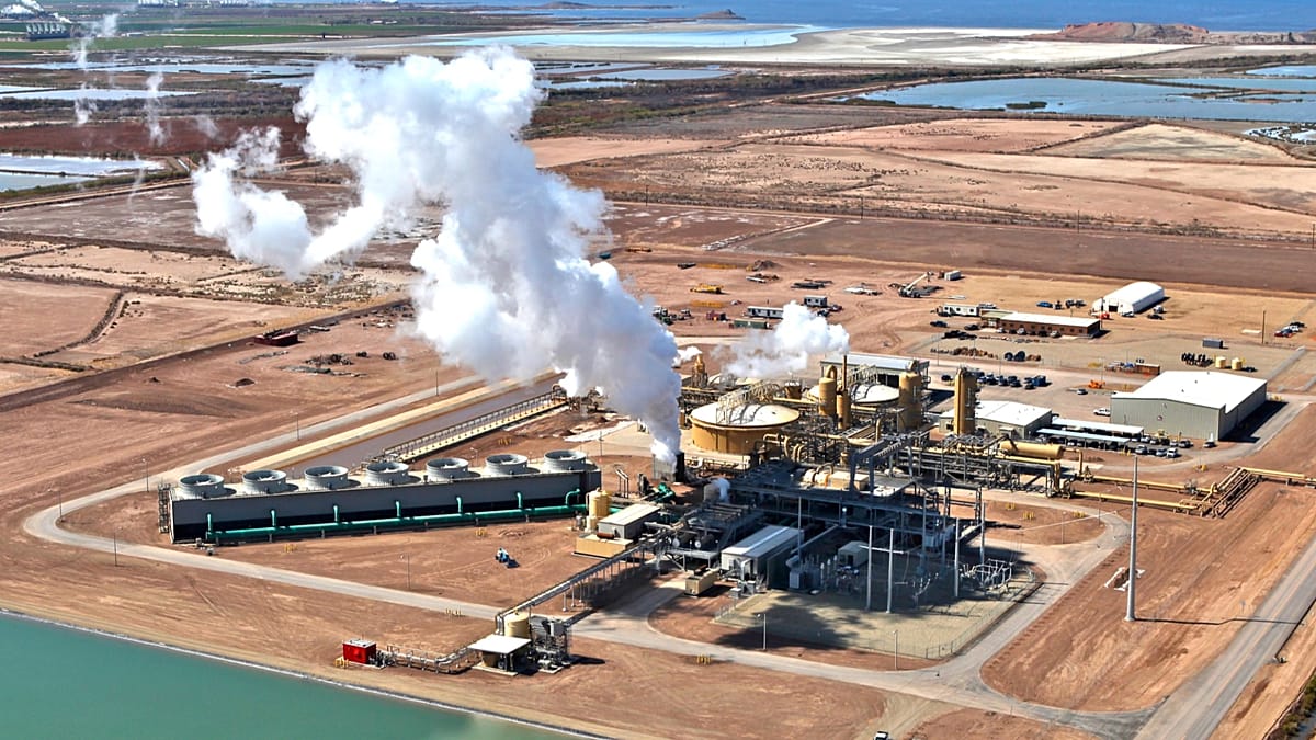 A cross-section diagram of a residential geothermal heat pump system connected to a solar array