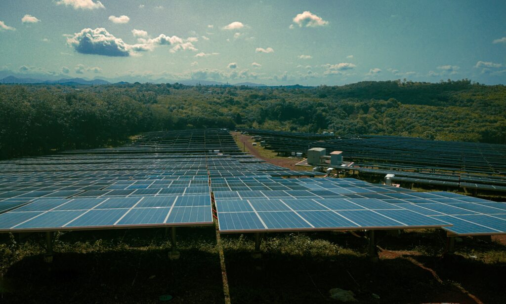 Aerial view of a large-scale solar farm with integrated battery storage containers in Spain.