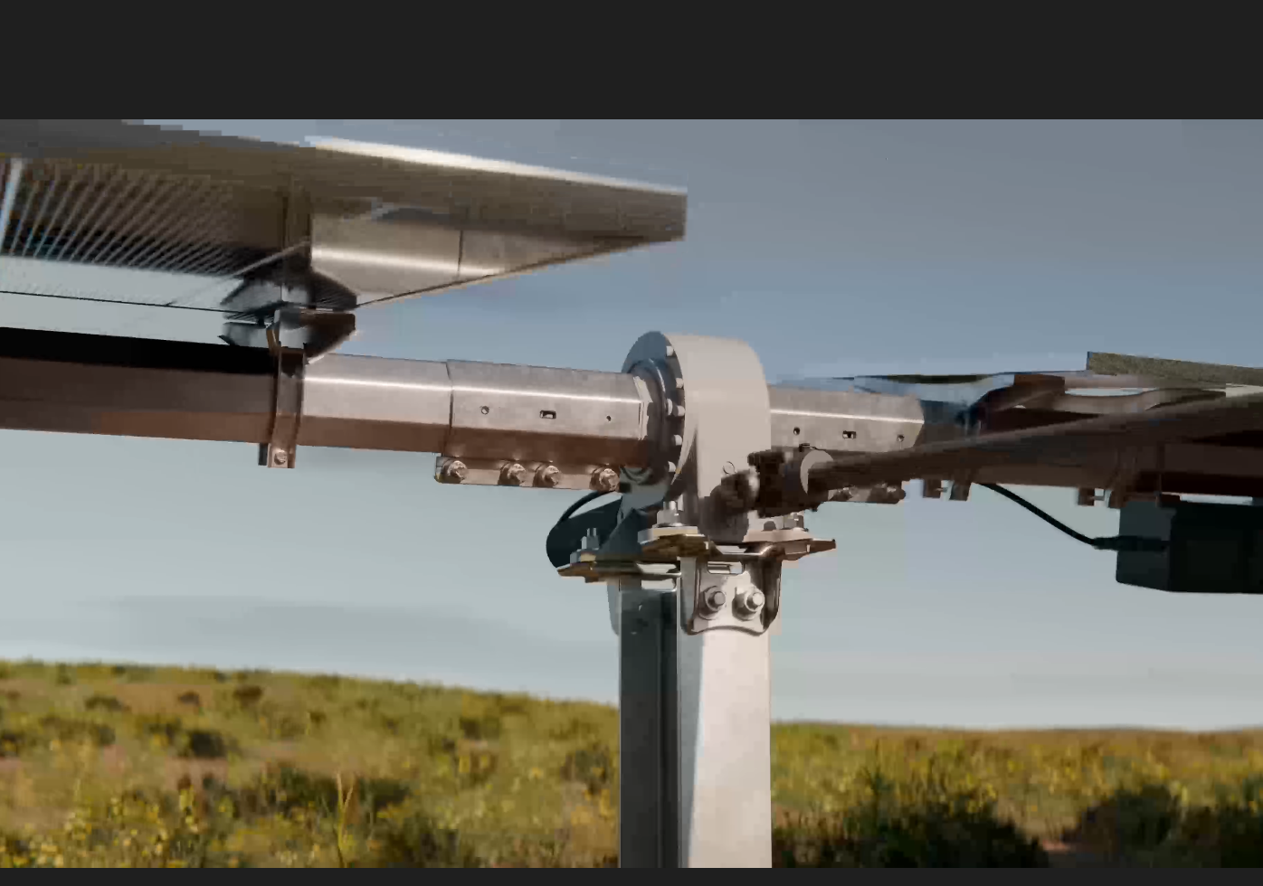 Close up of a solar tracker drive system on a sunny day with bifacial panels