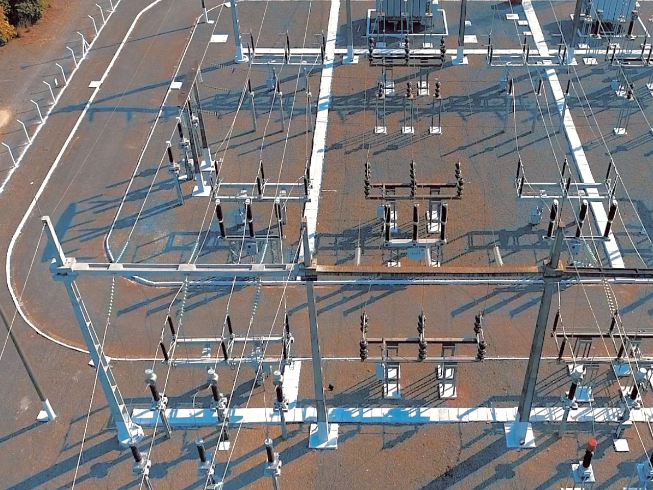 High-voltage power lines against a sunset, representing grid congestion and renewable energy bottlenecks in Europe.