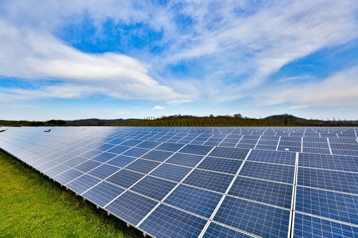A rows of solar panels on an Italian industrial rooftop at sunset