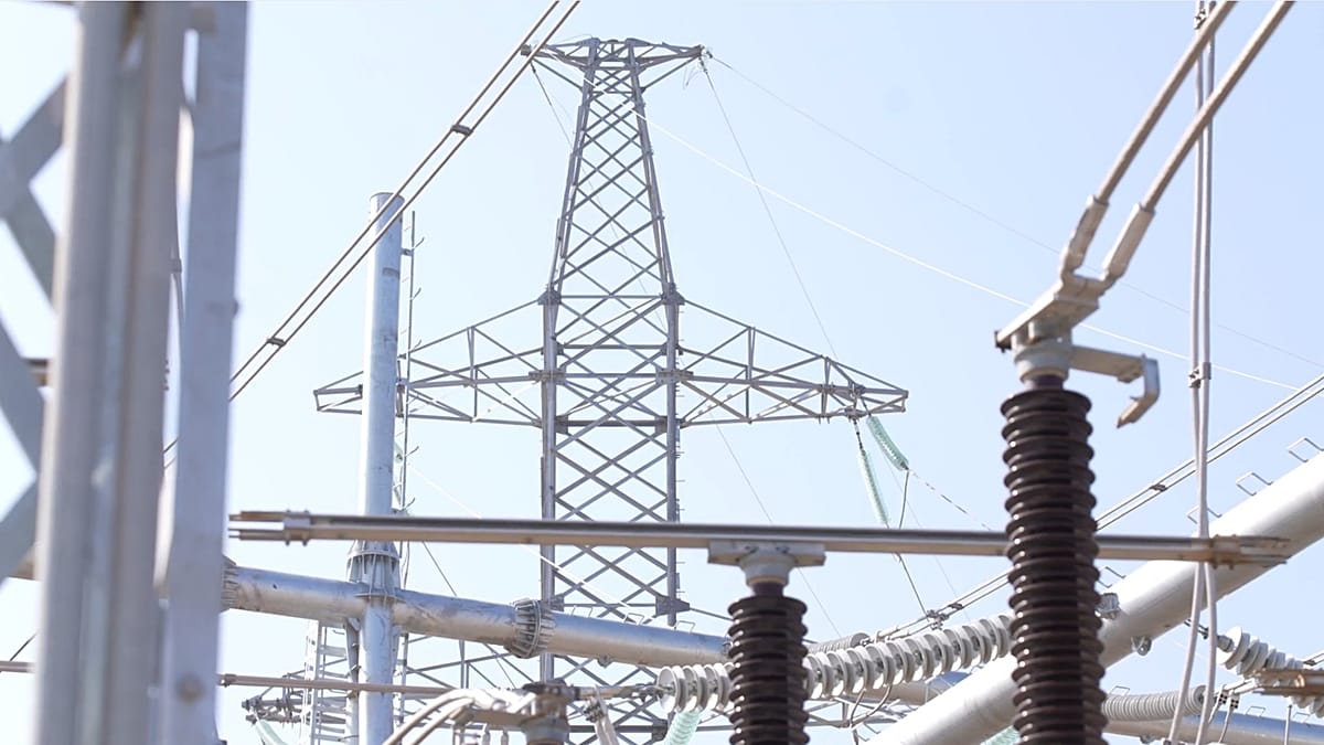 Large scale solar farm construction in a desert landscape with high-voltage power lines