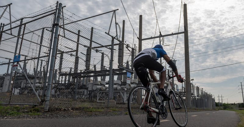 A digital visualization of a strained electrical grid connecting residential solar panels to a data center.