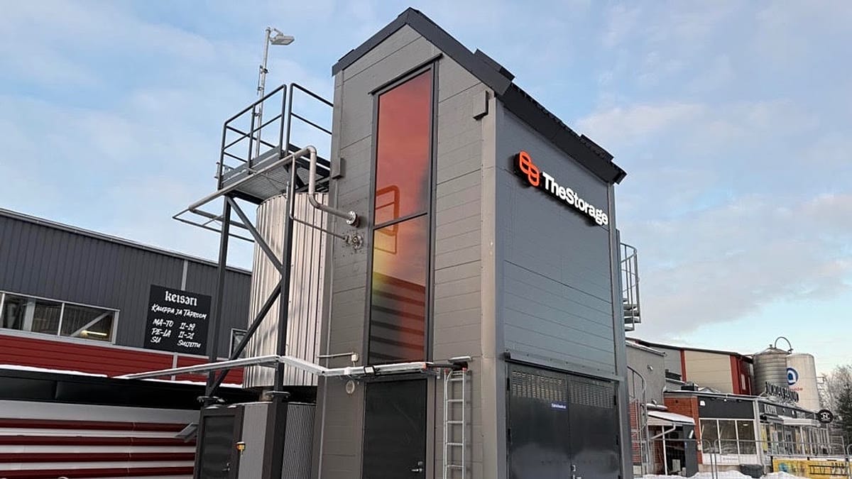 A large steel silo filled with sand used for industrial renewable thermal energy storage in Finland.